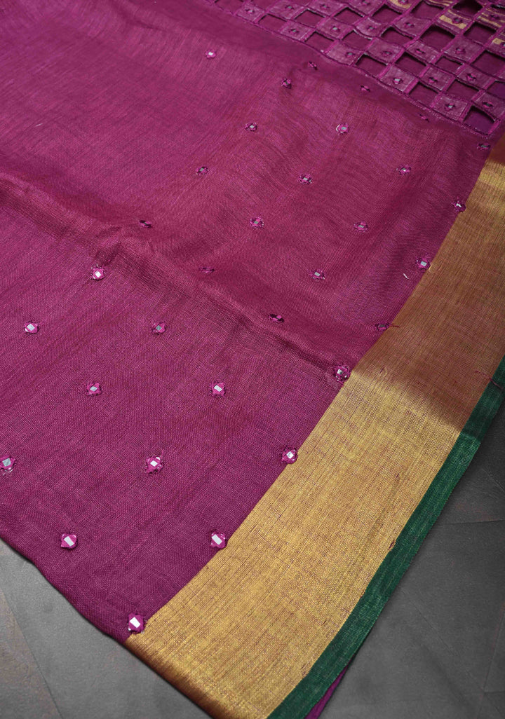 Magenta Cutwork and Mirror Work Tissue Linen Saree with dramatic tassels