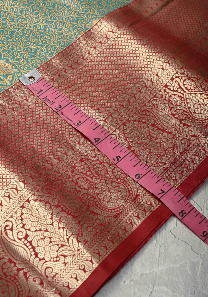 Teal Brocade Jaal on Kanjivaram Tissue Semi Silk Saree with Meenakari Buttas and Contrast Zari Border