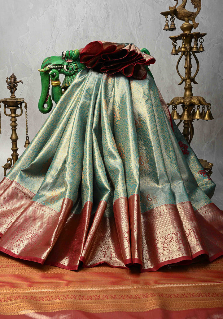 Teal Brocade Jaal on Kanjivaram Tissue Semi Silk Saree with Meenakari Buttas and Contrast Zari Border