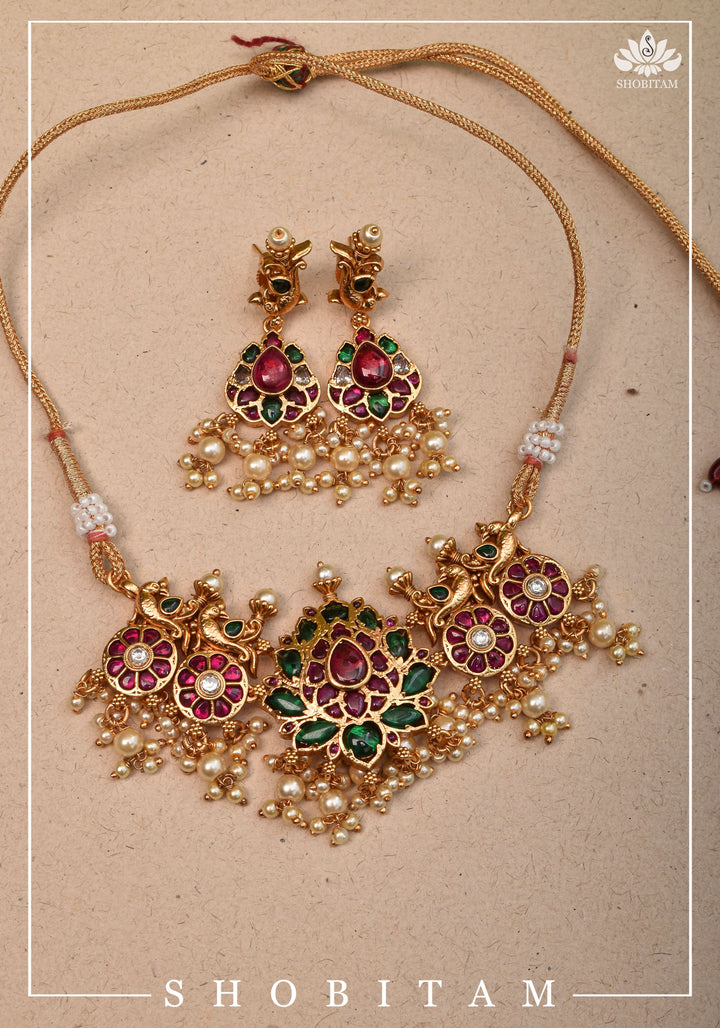 Jadau Lotus Stone Embellishment with Peacock units Choker Set In Green,Pink and white With Matching Earrings