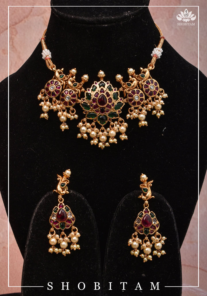Jadau Lotus Stone Embellishment with Peacock units Choker Set In Green,Pink and white With Matching Earrings