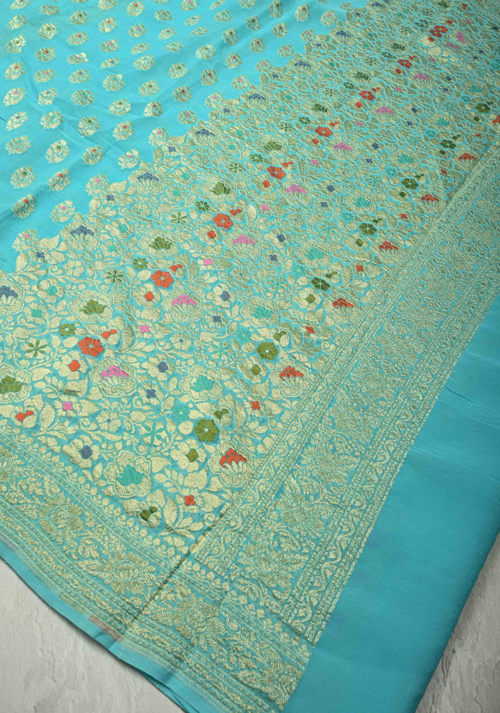 Authentic Turquoise Meenakari Work on Banarasi Silk Georgette Saree with Floral Buttas and 2 Side Equal Ornate Skirt Border | SILK MARK CERTIFIED