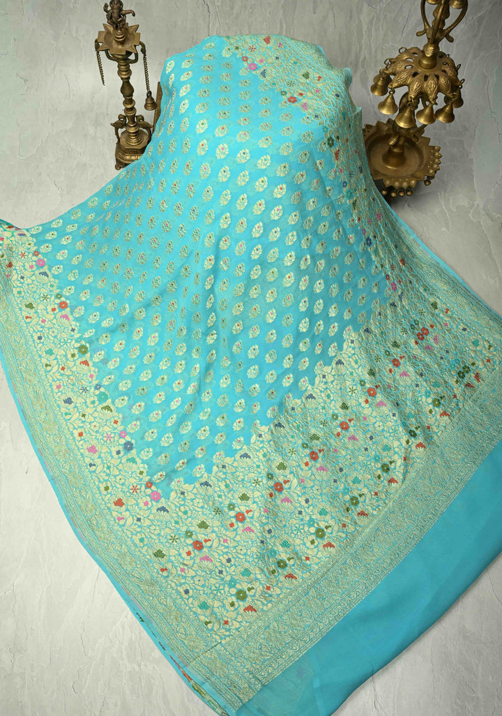Authentic Turquoise Meenakari Work on Banarasi Silk Georgette Saree with Floral Buttas and 2 Side Equal Ornate Skirt Border | SILK MARK CERTIFIED