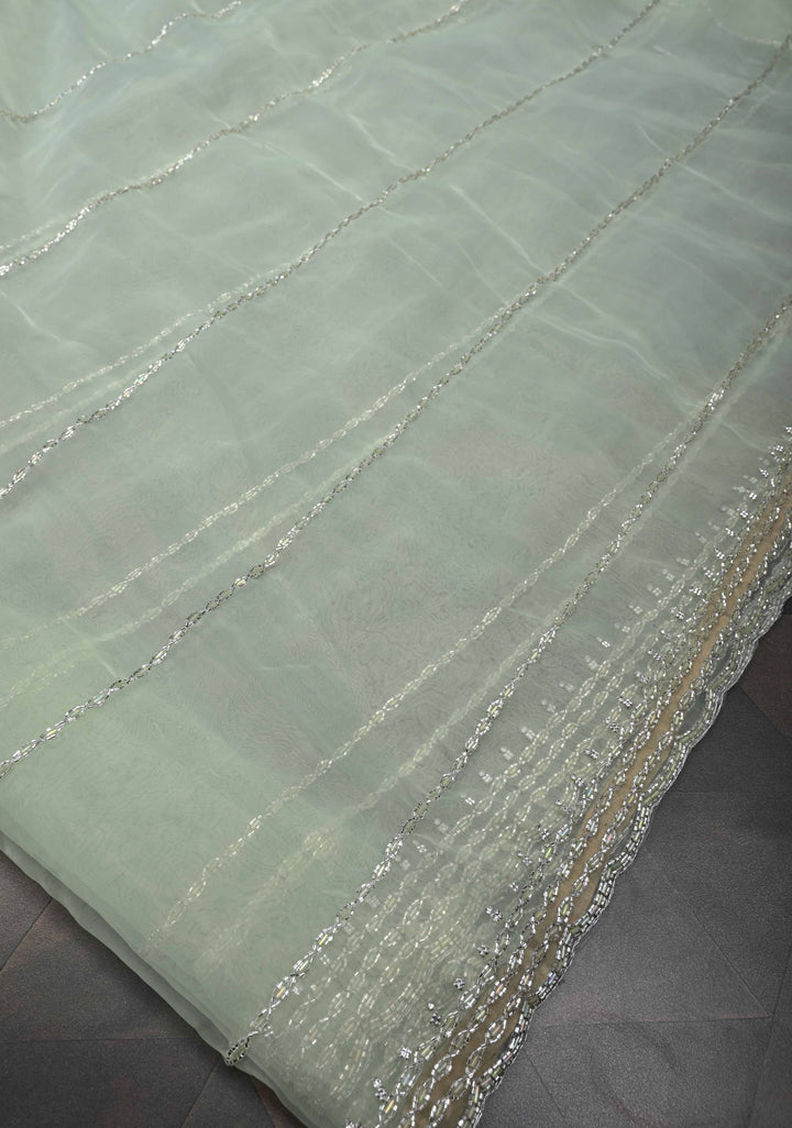 Dewy Pista Green Organza Saree with Horizontal Stripes Cutdana and Beads Embroidery Scallop Border