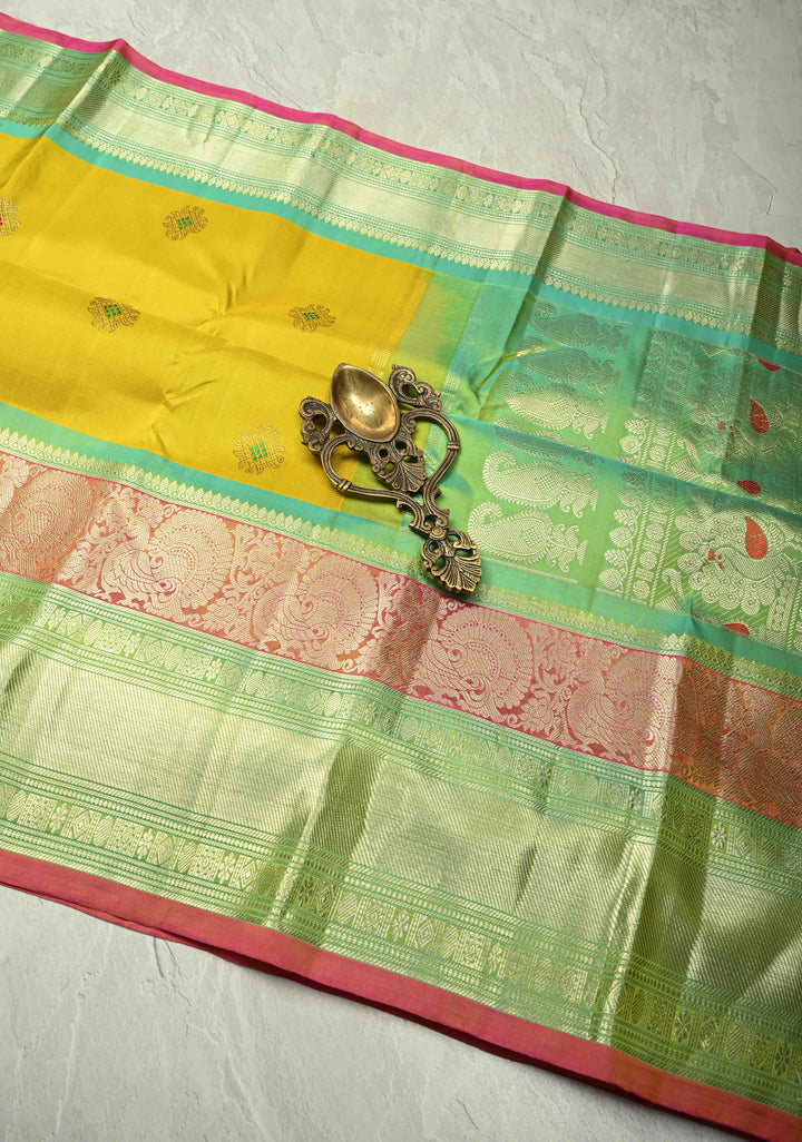 Yellow Gadwal Handwoven Pure Silk Saree with Meenakari Rangoli Zari Buttas with Pink and Teal Border | SILK MARK CERTIFIED