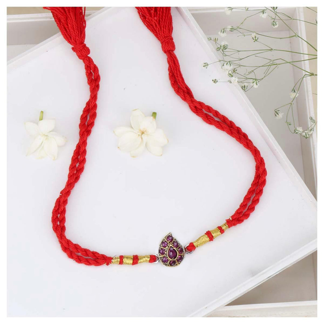 Pure 92.5 Thilagam Siloni Silver Rakhi with Tear Drop Shaped Motif, Purple Beads and Dori Tie