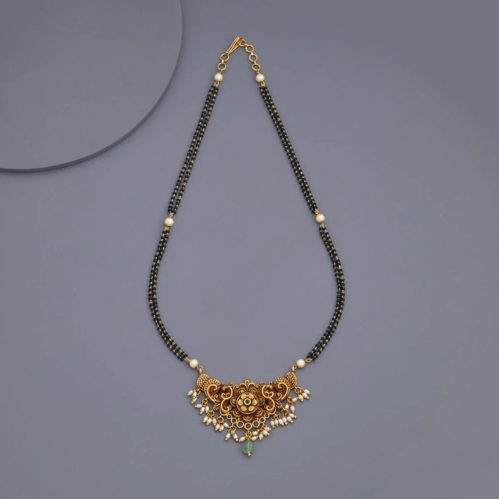 Traditional Gold-Tone Black Bead Mangalsutra with Intricate Flower Design and Pearl, Green Stone Accents