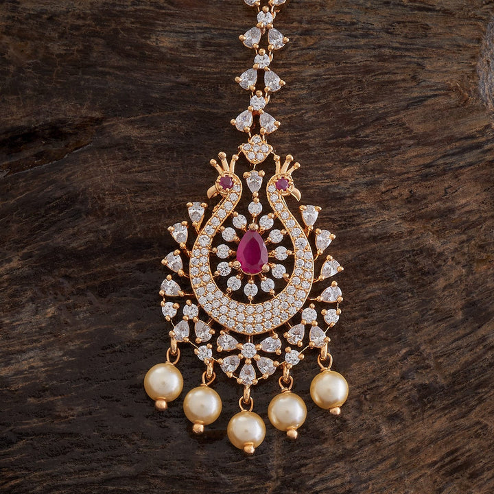 Flower Motif Handcrafted gold-polished Tikka embellished with synthetic stones and beads in Ruby