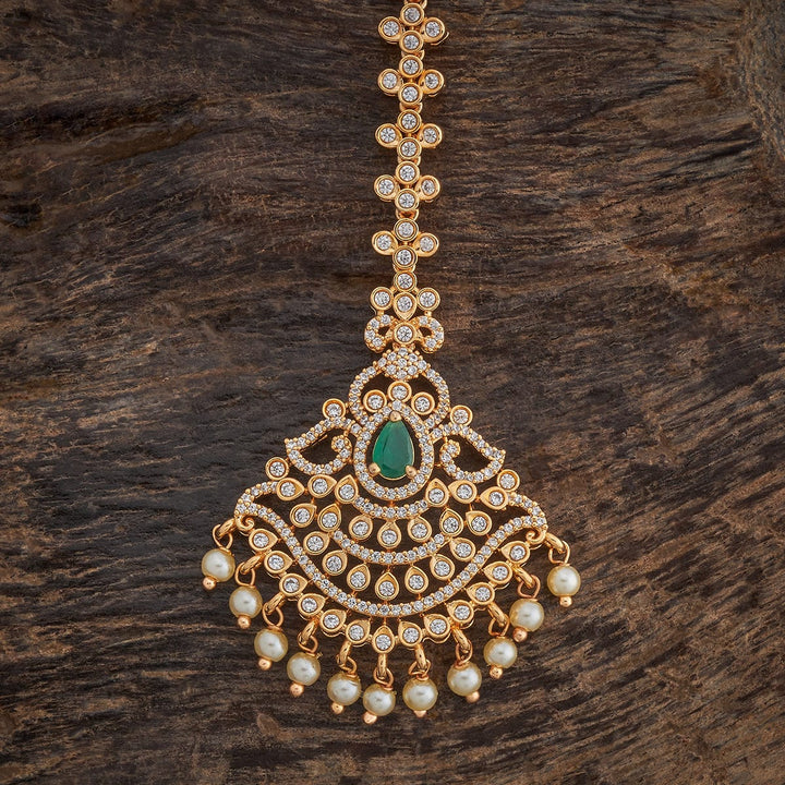 Traditional Design Tikka with shimmering white Green stones and beads finished in luxurious gold polish