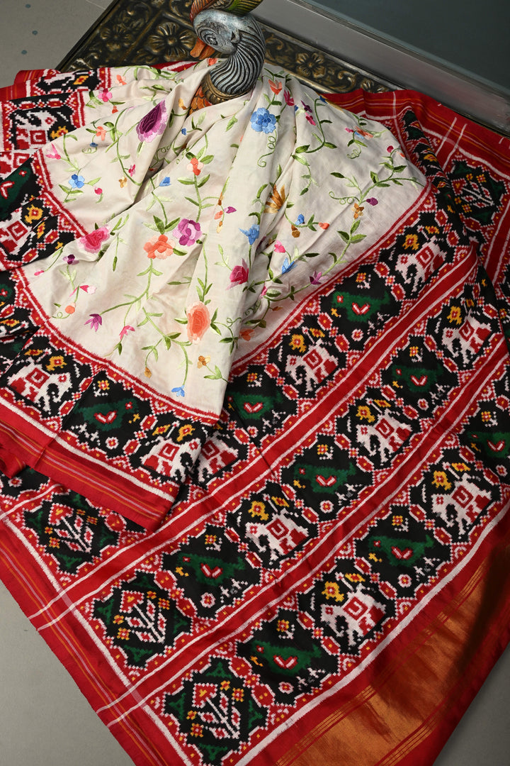 Ivory Jugalbandi Authentic Patan Patola Double Ikkat Pure Silk Saree With Parsi Gara Hand Embroidery Floral Jaal and Contrst Black Pallu on Both Side | SILK MARK CERTIFIED | SHOBITAM