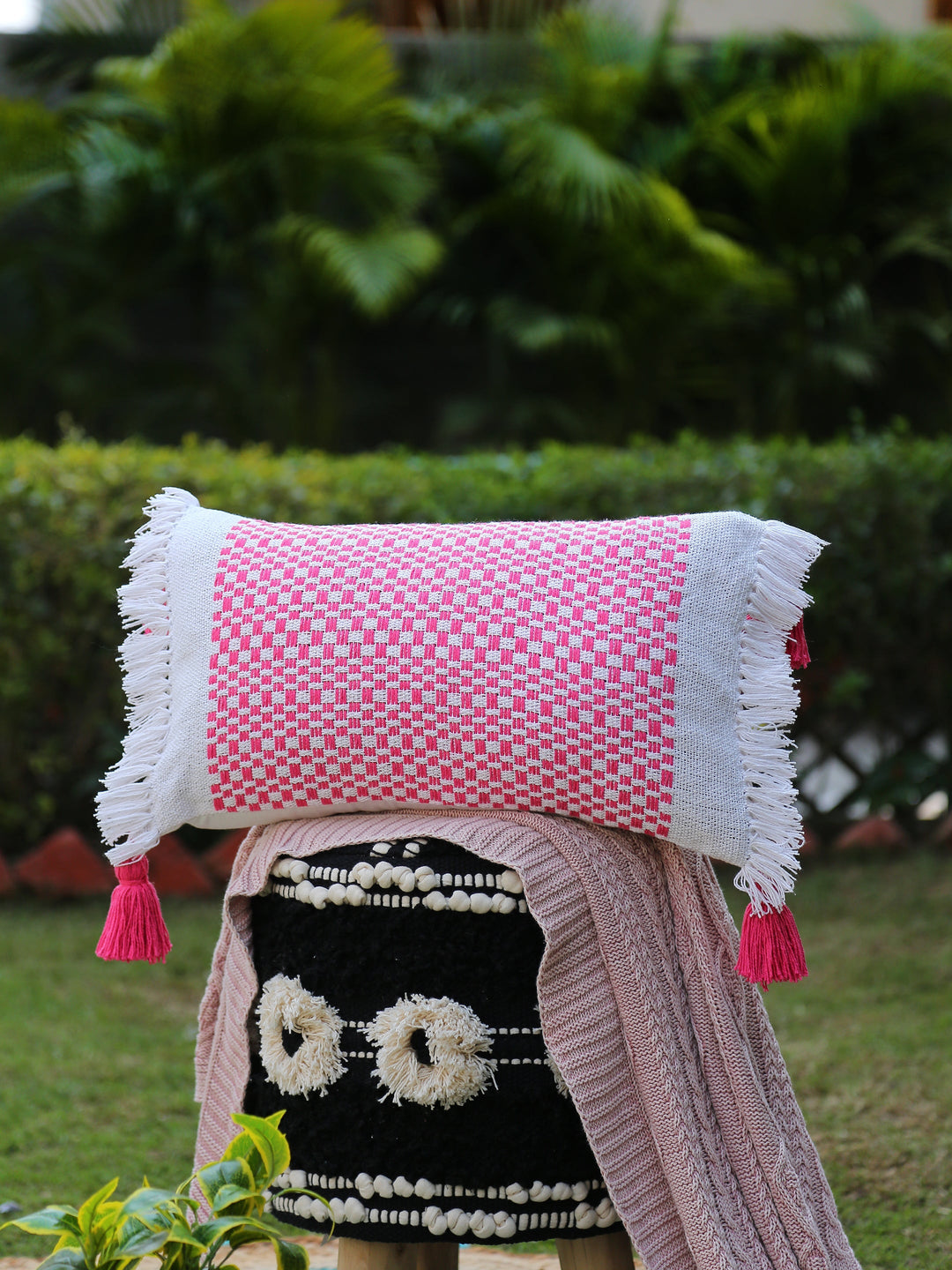 Hand woven cushion cover with tassels and fringes in pink and white