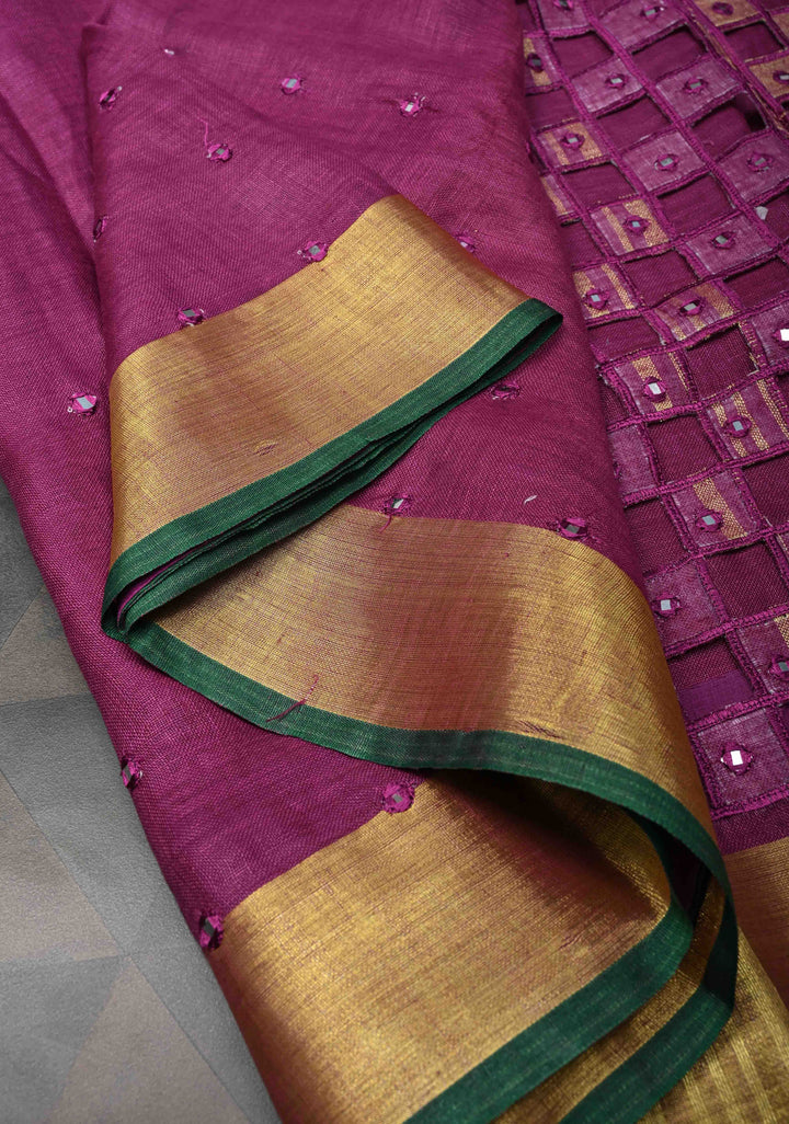 Magenta Cutwork and Mirror Work Tissue Linen Saree with dramatic tassels