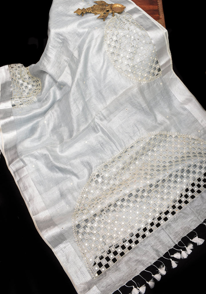 Cutwork and Mirror Work Tissue Linen Saree in White Silver with dramatic tassels