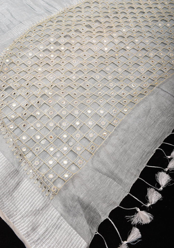 Cutwork and Mirror Work Tissue Linen Saree in White Silver with dramatic tassels