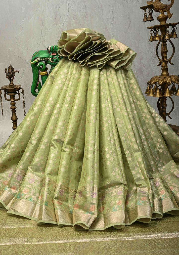 Light olive Green Tissue Kanjivaram Semi Silk Saree with Leaf Buttas and Pastel meenakari Vine border