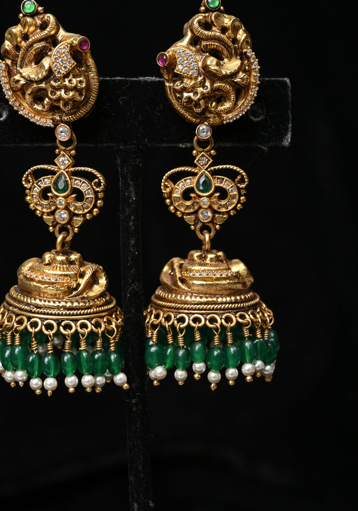 Preorder : 92.5 Silver, 22 kt Gold-Plated Jhumka Earrings with Peacock and Floral Motifs