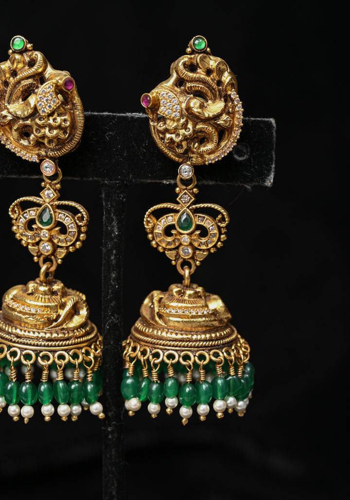 Preorder : 92.5 Silver, 22 kt Gold-Plated Jhumka Earrings with Peacock and Floral Motifs