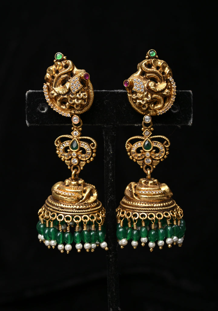 Preorder : 92.5 Silver, 22 kt Gold-Plated Jhumka Earrings with Peacock and Floral Motifs