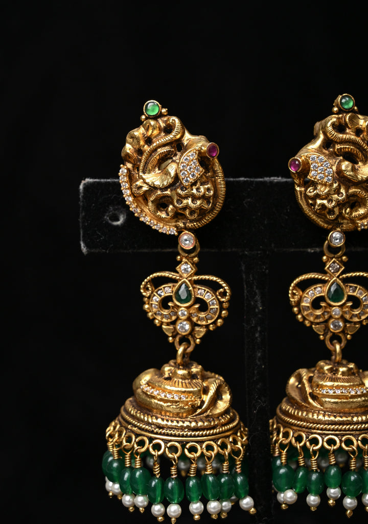 Preorder : 92.5 Silver, 22 kt Gold-Plated Jhumka Earrings with Peacock and Floral Motifs