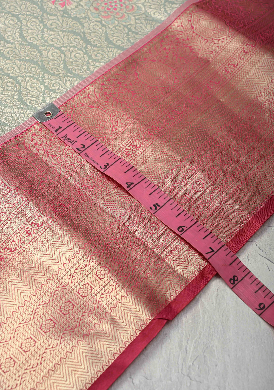 Sage Green Floral Brocade on Kanjivaram Tissue Semi Silk Saree with Meenakari Buttas and Contrast Zari Border