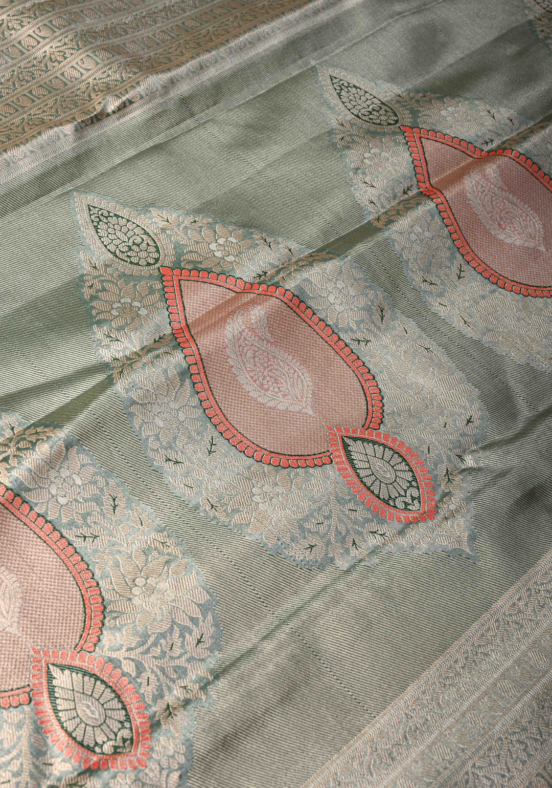 Salmon Brocade Jaal on Kanjivaram Tissue Semi Silk Saree with Meenakari Buttas and Contrast Zari Border