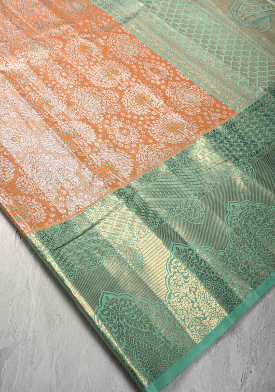 Orange Brocade on Kanjivaram Tissue Semi Silk Saree with Meenakari Buttas and Contrast Wide Zari Border