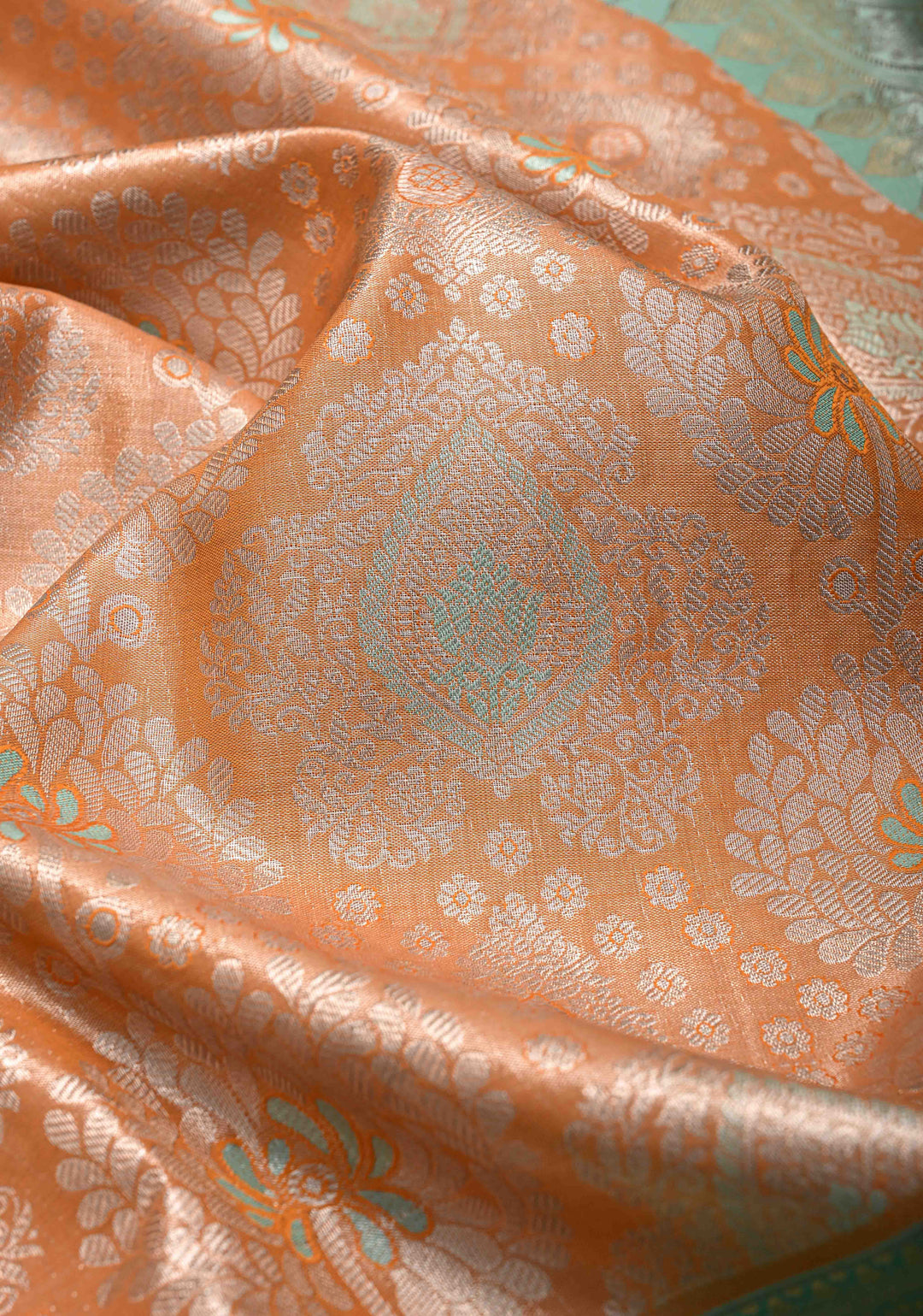 Orange Brocade on Kanjivaram Tissue Semi Silk Saree with Meenakari Buttas and Contrast Wide Zari Border