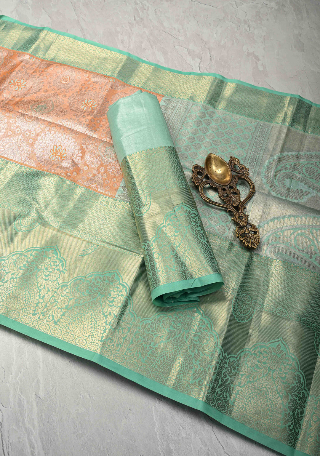 Orange Brocade on Kanjivaram Tissue Semi Silk Saree with Meenakari Buttas and Contrast Wide Zari Border