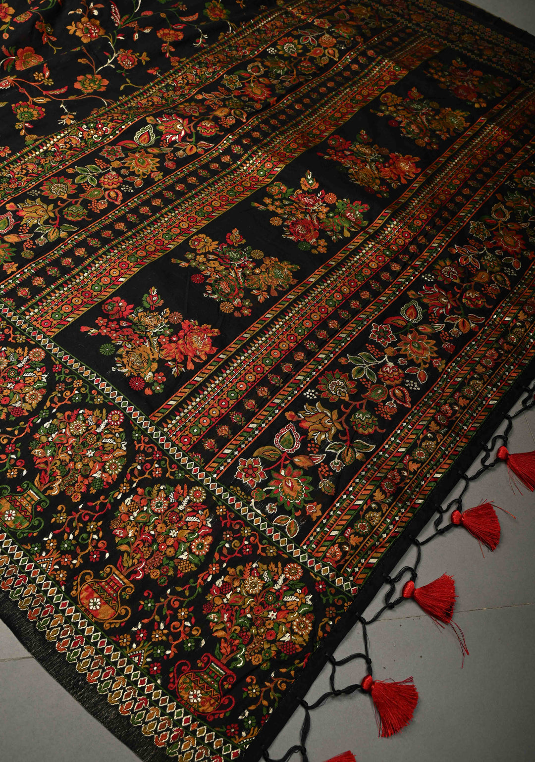 Black Rayon Saree adorned with a Traditional Kani Floral Jaal Pattern. | SHOBITAM