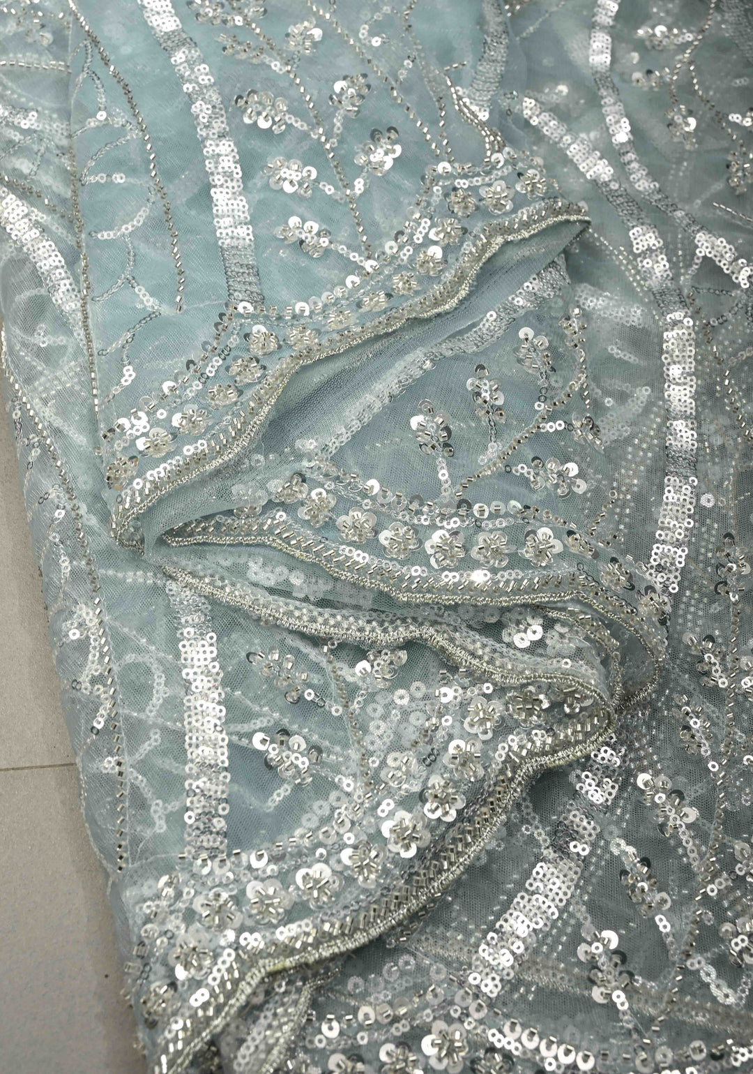 Powder Blue Swirling Design Sequins, Cutdana on Net Saree with Scallop Border | SHOBITAM