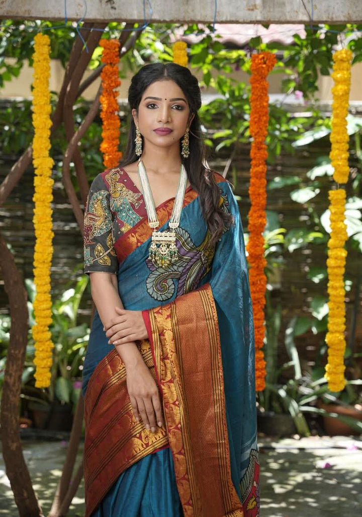 PreOrder: Peacock blue Narayanpet saree with pen kalamkari appliqué and wide zari borders