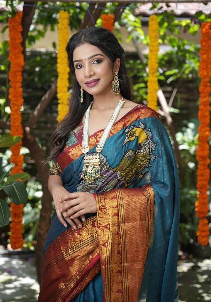PreOrder: Peacock blue Narayanpet saree with pen kalamkari appliqué and wide zari borders