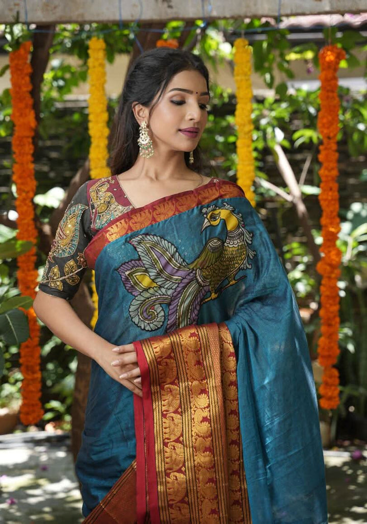 PreOrder: Peacock blue Narayanpet saree with pen kalamkari appliqué and wide zari borders