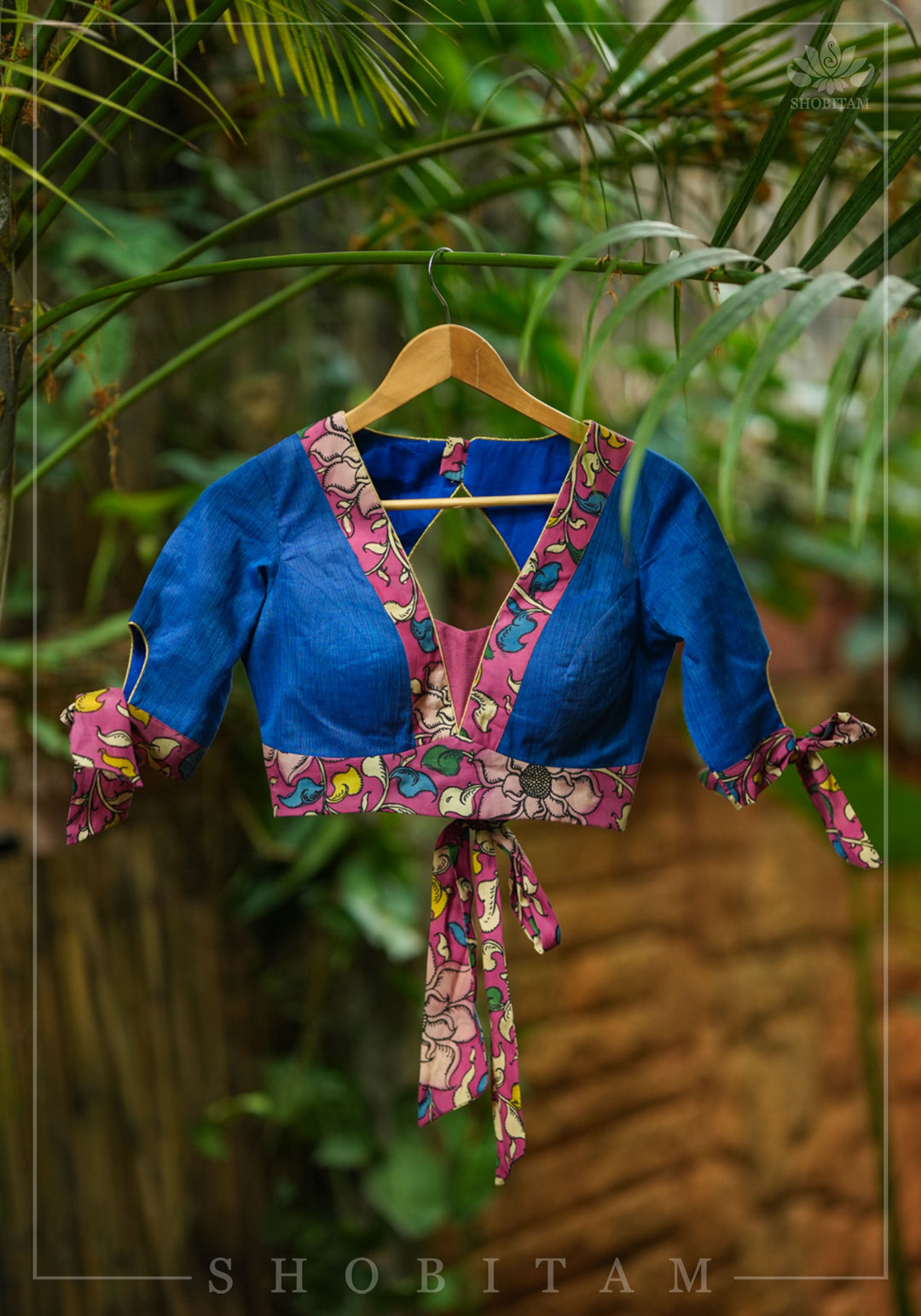 Ocean blue handloom V neck blouse with rose pink handpainted kalamkari border detailing.