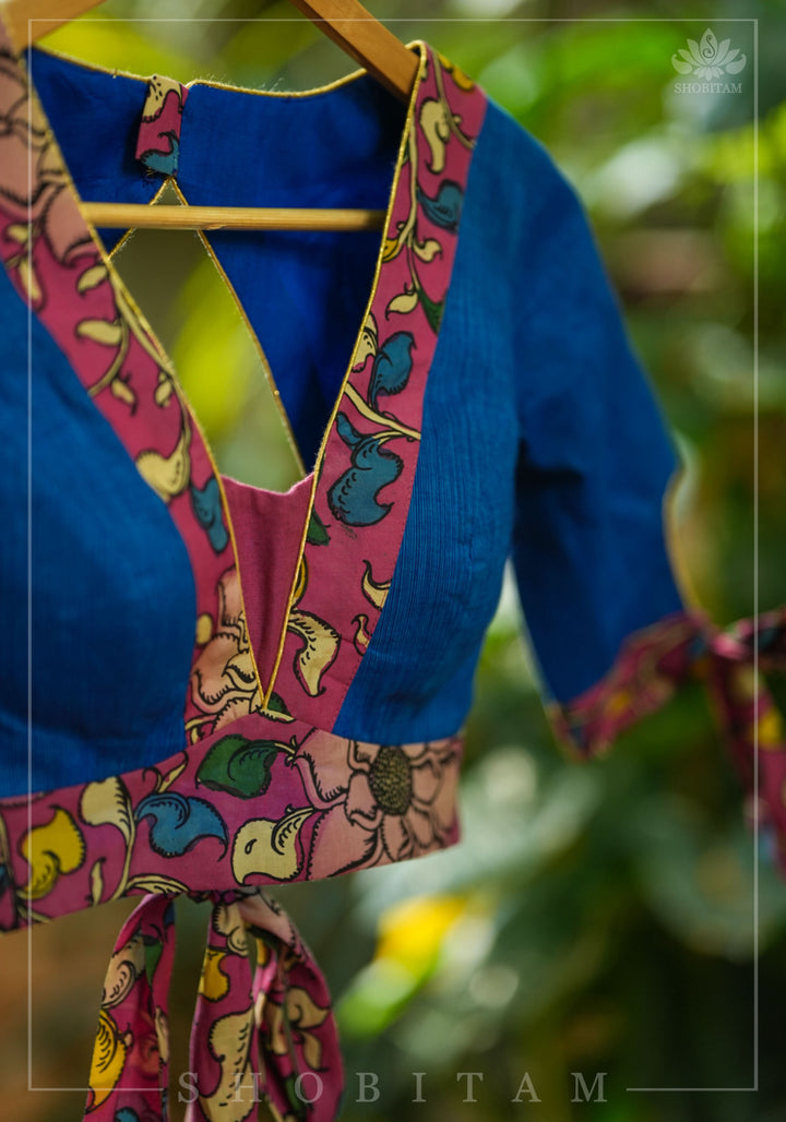 Ocean blue handloom V neck blouse with rose pink handpainted kalamkari border detailing.