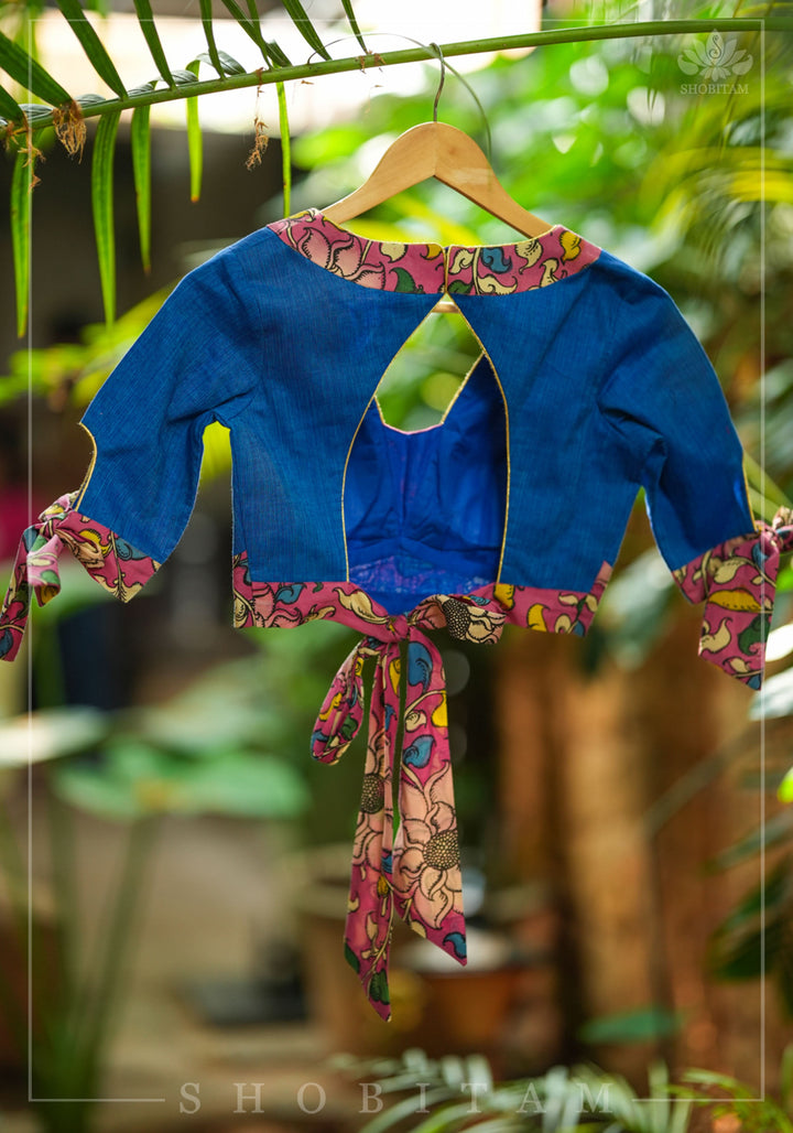 Ocean blue handloom V neck blouse with rose pink handpainted kalamkari border detailing.