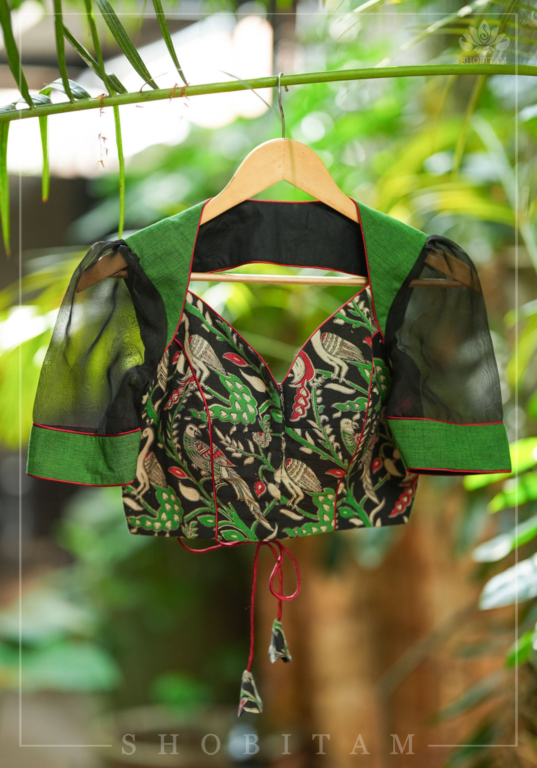 Forest green and black handpainted kalamkari sweetheart neck blouse with black chiffon sleeves.