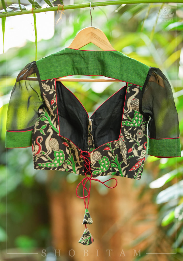 Forest green and black handpainted kalamkari sweetheart neck blouse with black chiffon sleeves.