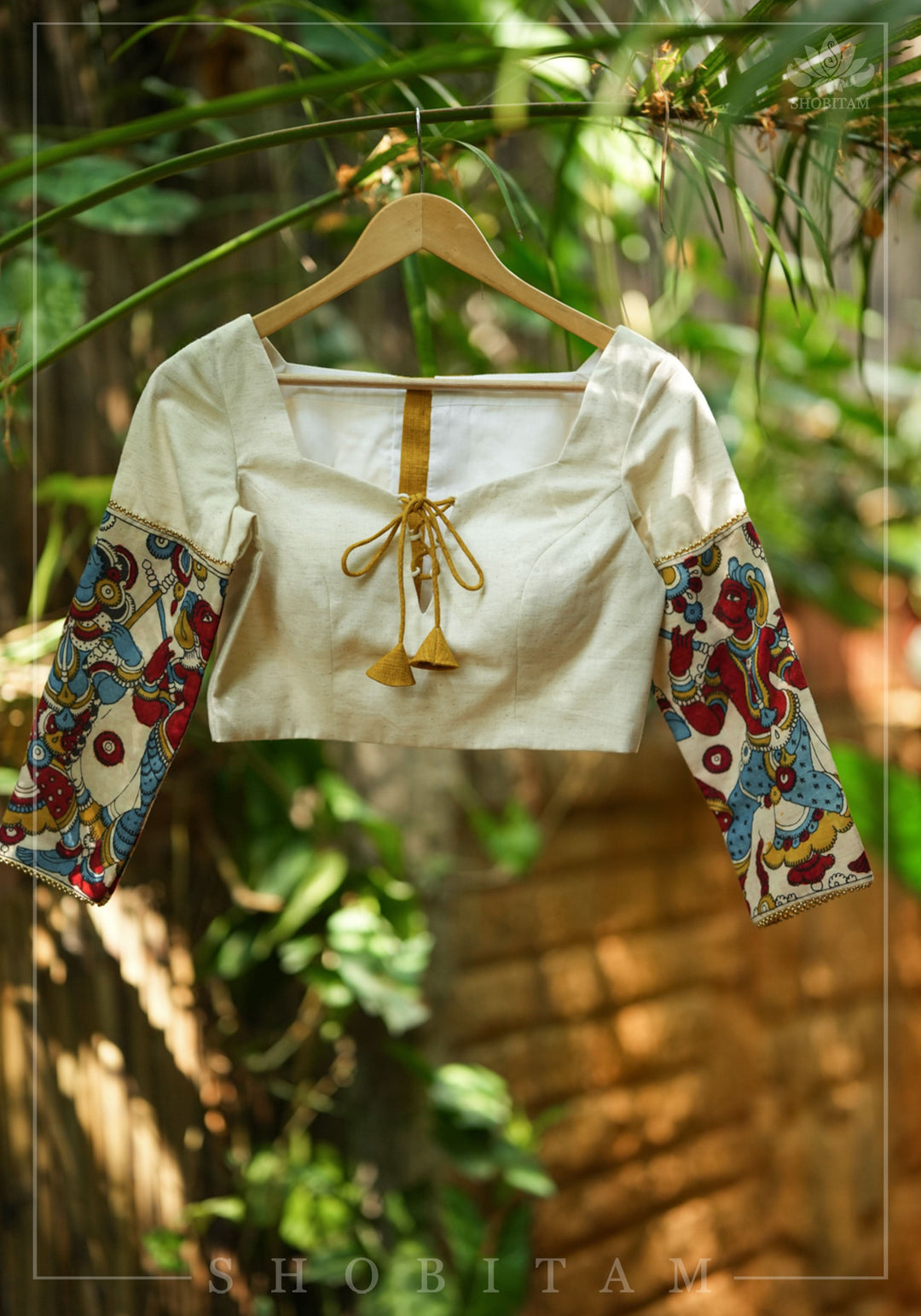 Porcelain white square neck blouse with handpainted kalamkari sleeve detailing.