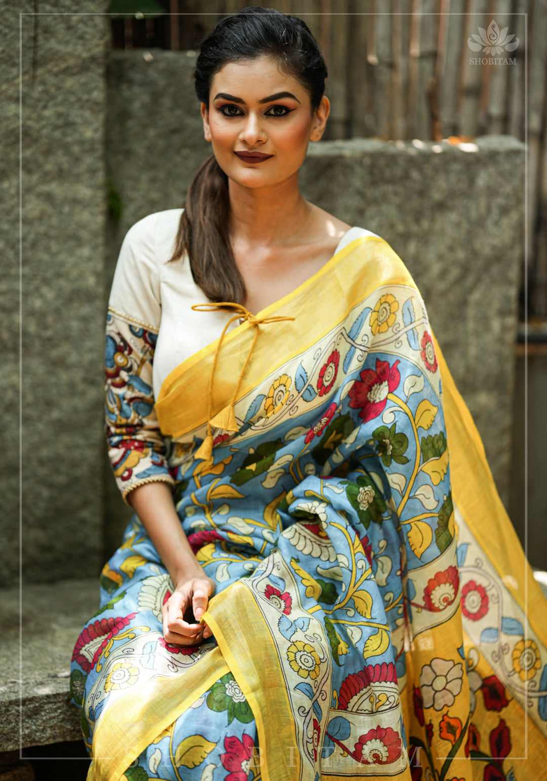Porcelain white square neck blouse with handpainted kalamkari sleeve detailing.