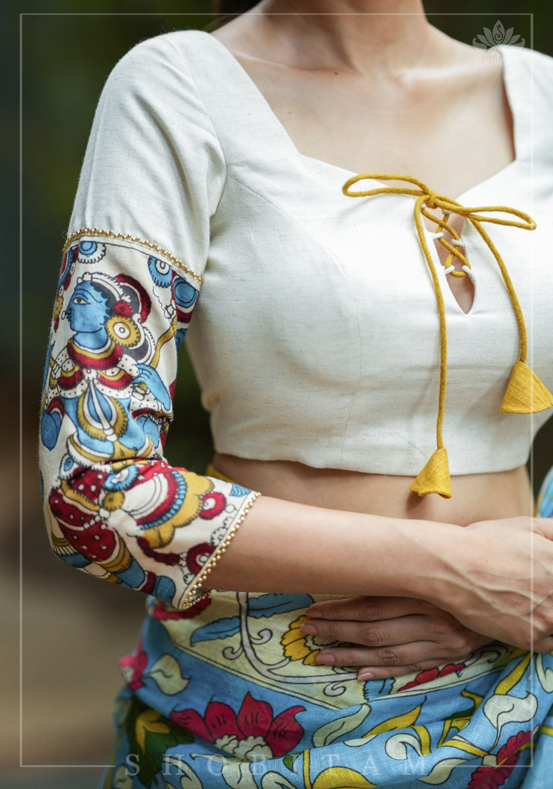 Porcelain white square neck blouse with handpainted kalamkari sleeve detailing.