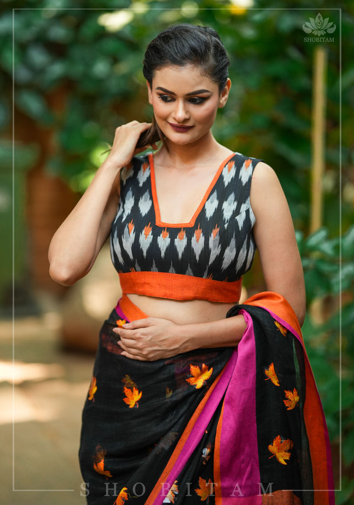Black and orange cotton Ikkat square neck sleeveless blouse with orange handloom border.