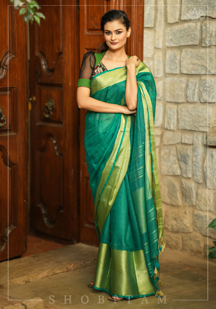 Forest green and black handpainted kalamkari sweetheart neck blouse with black chiffon sleeves.