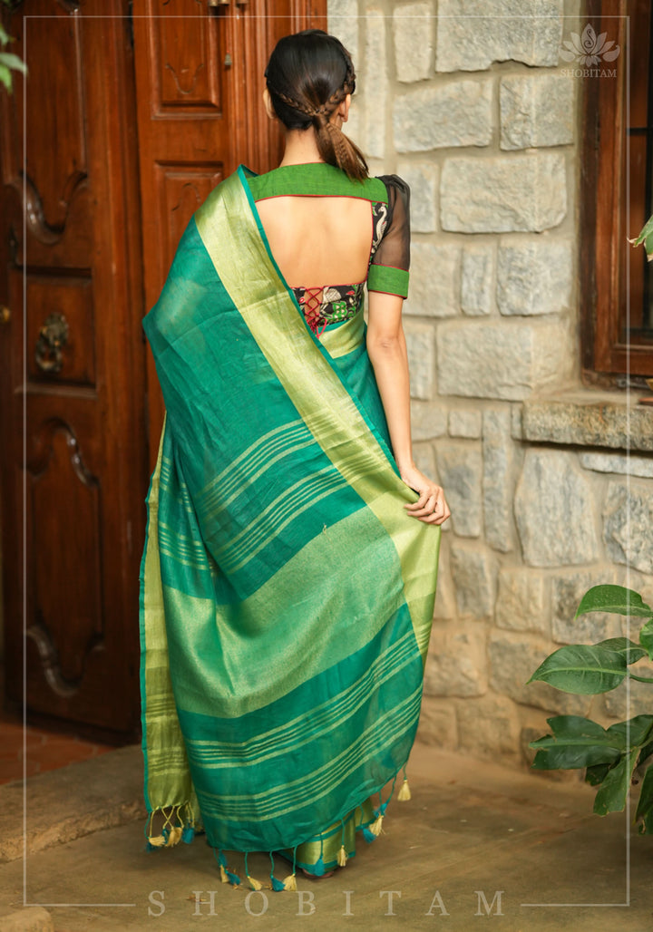 Forest green and black handpainted kalamkari sweetheart neck blouse with black chiffon sleeves.
