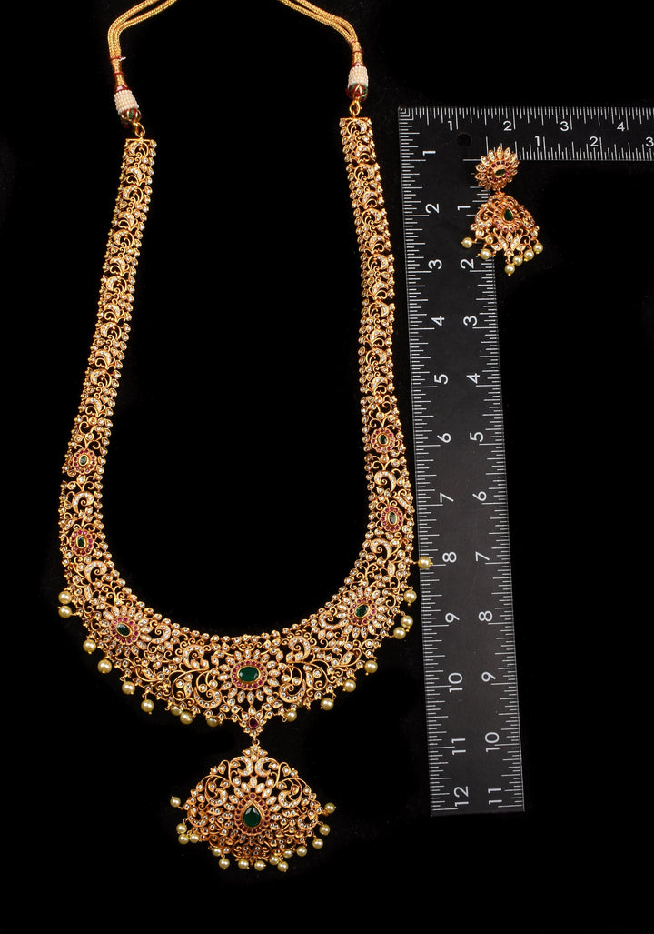 Timeless Elegance: Intricate Gold-Finish Long Haram Set with Gemstones and Pearls