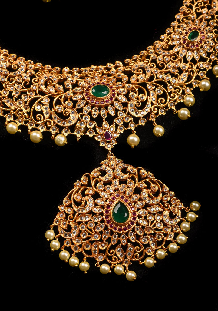 Timeless Elegance: Intricate Gold-Finish Long Haram Set with Gemstones and Pearls