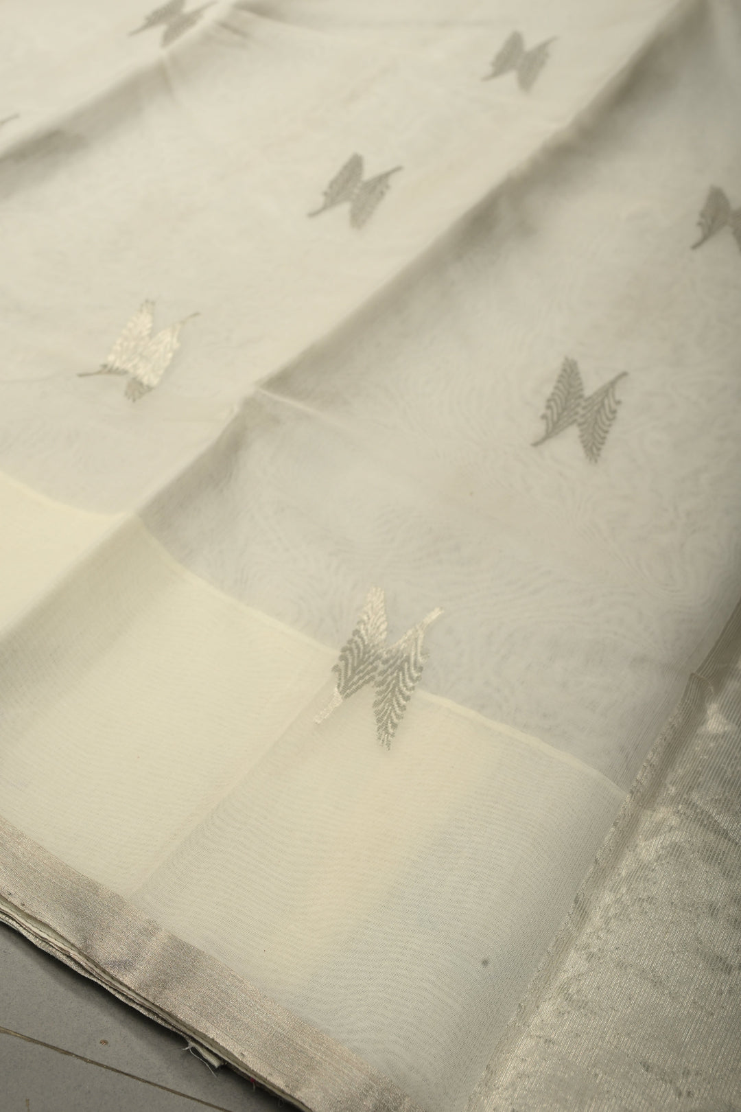White Chanderi Silk Saree with Floral Silver Zari Buttas and Minimal Tissue Zari Border | SHOBITAM
