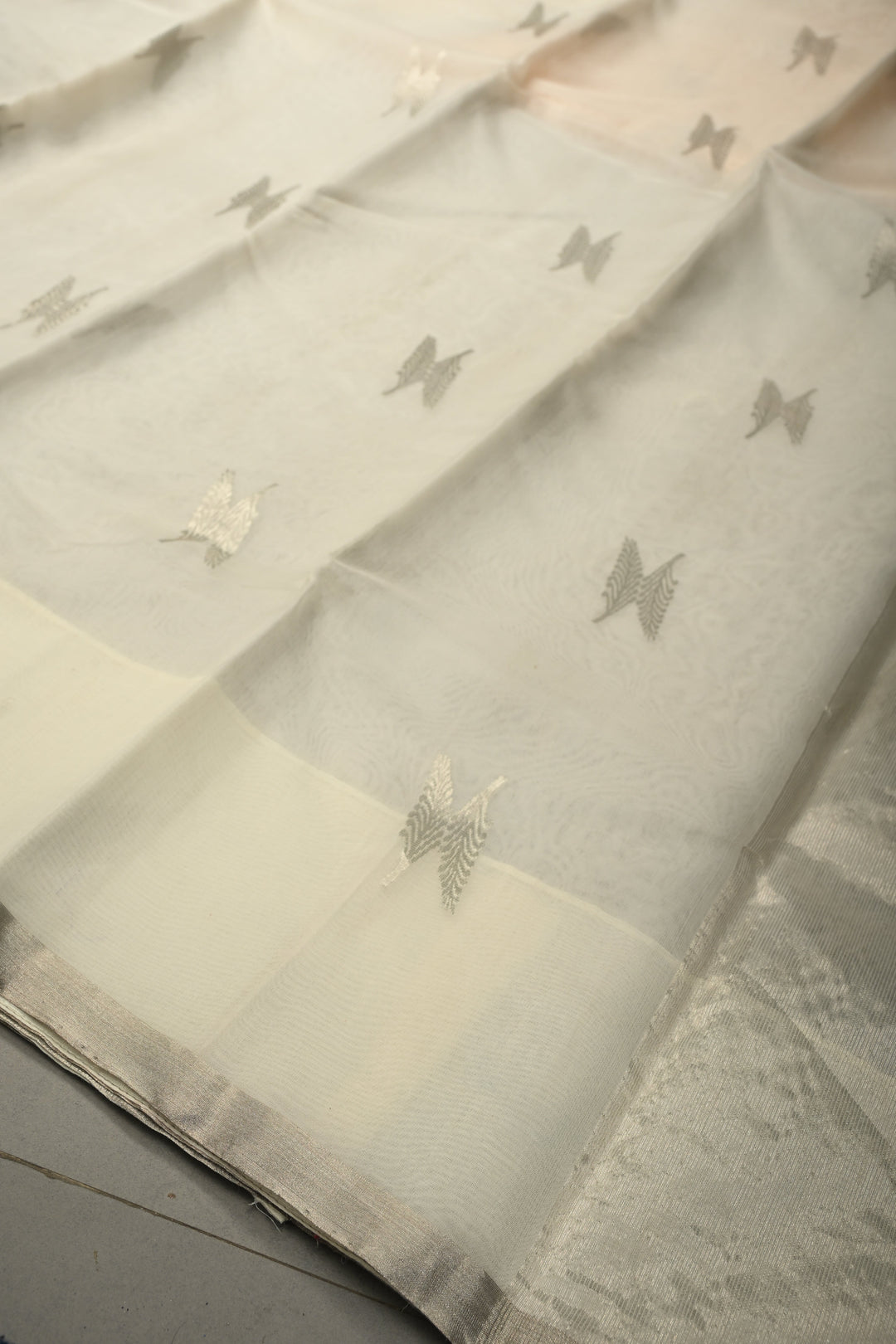 White Chanderi Silk Saree with Floral Silver Zari Buttas and Minimal Tissue Zari Border | SHOBITAM