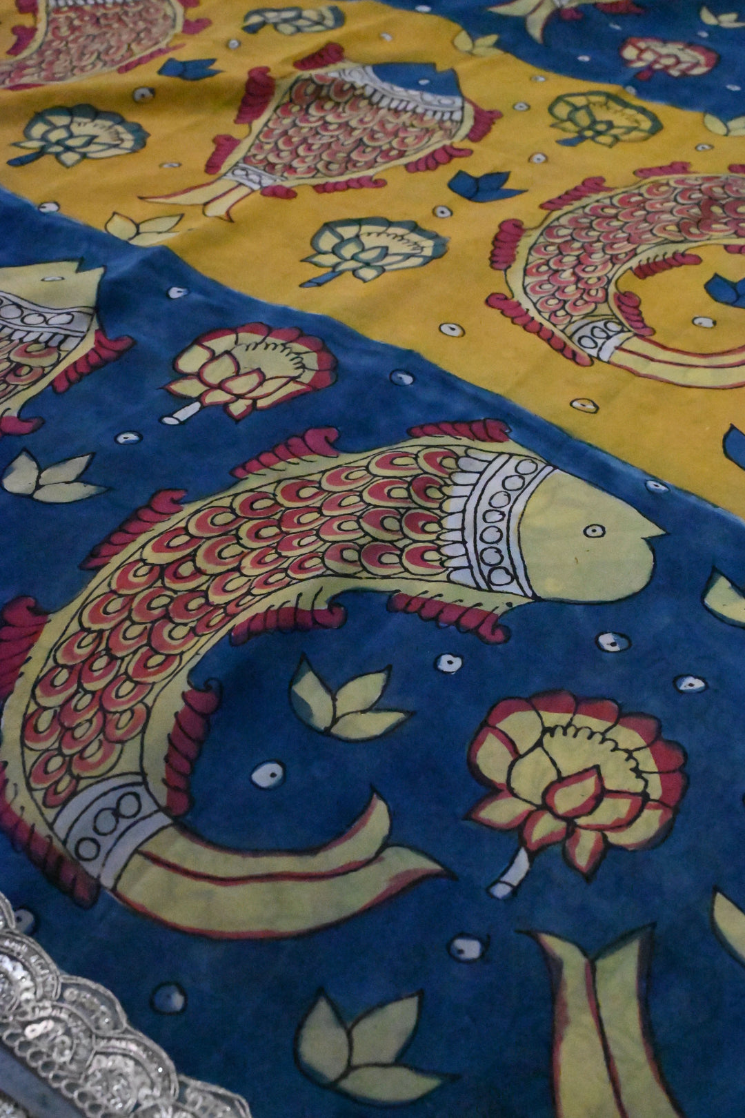 Floral and Matsya Theme : Yellow and Blue Authentic Pen Kalamkari on Banarasi Pure Georgette Saree with Fancy Lace Border  | SILK MARK CERTIFIED | SHOBITAM