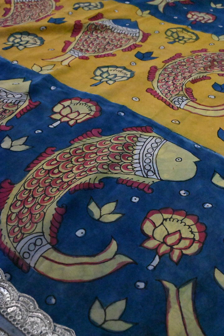 Floral and Matsya Theme : Yellow and Blue Authentic Pen Kalamkari on Banarasi Pure Georgette Saree with Fancy Lace Border  | SILK MARK CERTIFIED | SHOBITAM